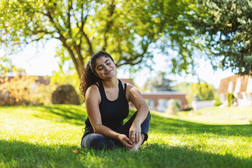 In Western Colorado Teenage Female of LatinX Ethnicity Relaxing in Front Yard in Summertime Afro-Lat...