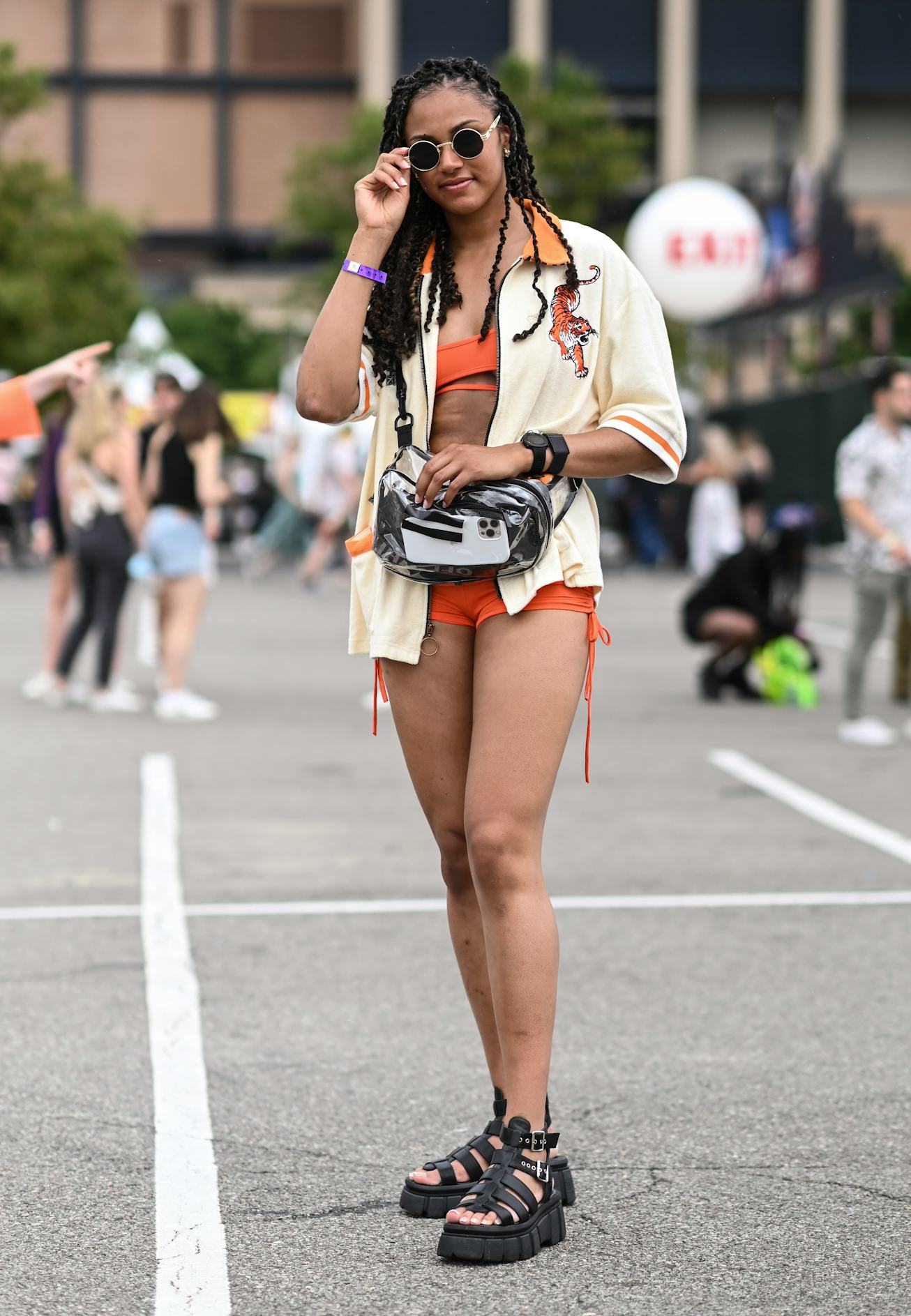 NEW YORK, NEW YORK - JUNE 11: Tiana is seen wearing a Tombolo orange and cream jacket and black sand...