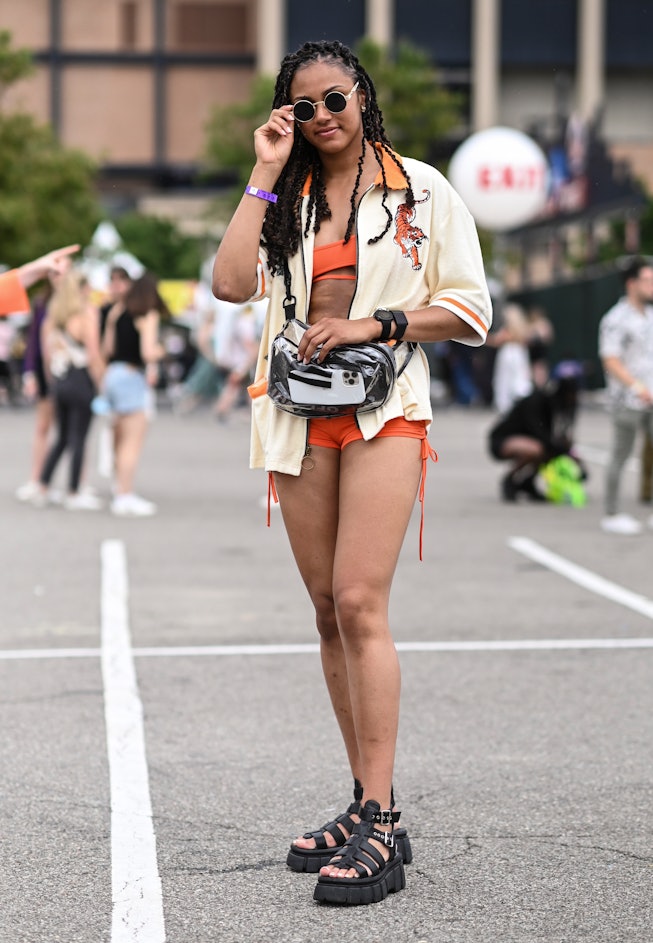 NEW YORK, NEW YORK - JUNE 11: Tiana is seen wearing a Tombolo orange and cream jacket and black sand...