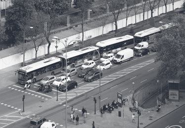 Elevated view of traffic stopped at a traffic light on Paseo de Recoletos, central Madrid, Spain.