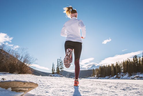 Sportive young woman exercising trail running on mountain trail in Alberta, Canada. People body cons...