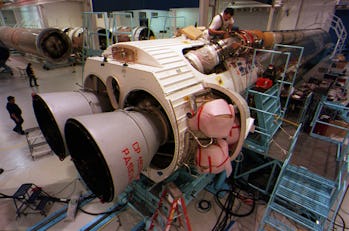 Mechanic Mike Montez works on insulating the Liquid Oxygen System on the Atlas III rocket that will ...