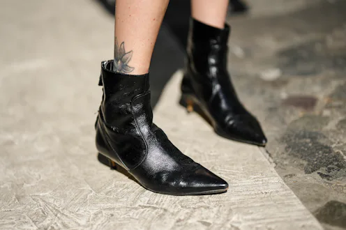 PARIS, FRANCE - APRIL 11: Emy Venturini wears black shiny leather pointed heels ankle shoes , during...