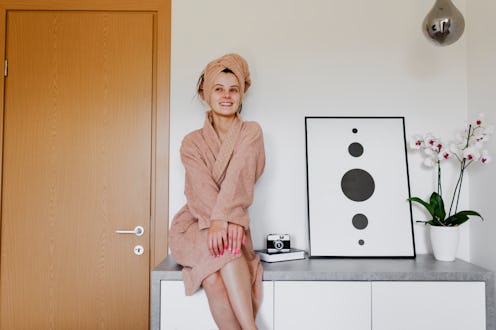 Young woman giving herself a spa treatment at home