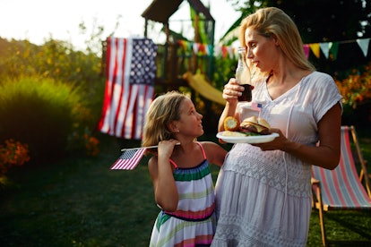 pregnant woman and daughter at july 4th bbq, can babies hear fireworks in the womb
