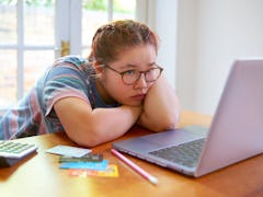 Worried student calculating debt