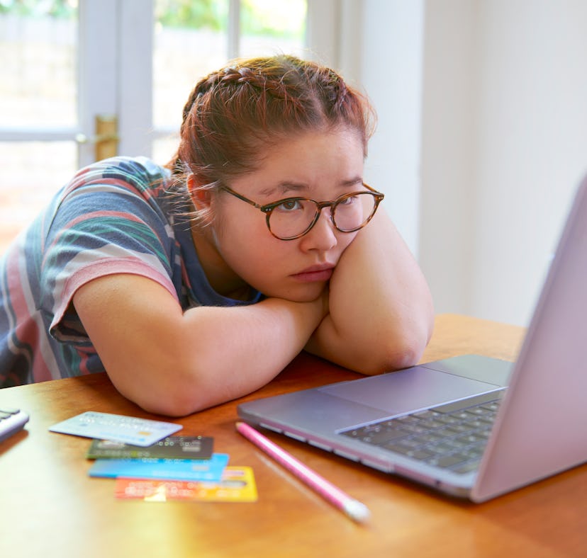 Worried student calculating debt