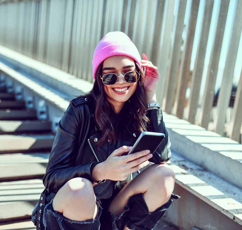 Girlfriend composing sweet long text message to her boyfriend.