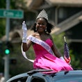 Miss Juneteenth 2015, Sean-Maree Swinger-Otey, 17, waves during a 4th of July Parade in Denver