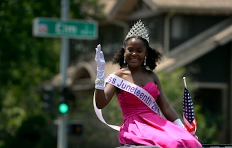 Miss Juneteenth 2015, Sean-Maree Swinger-Otey, 17, waves during a 4th of July Parade in Denver