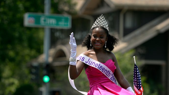 Miss Juneteenth 2015, Sean-Maree Swinger-Otey, 17, waves during a 4th of July Parade in Denver