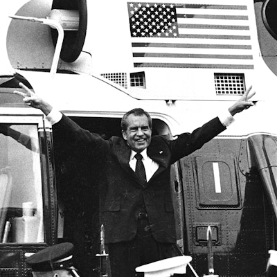 Richard Nixon, waves goodbye, as he departs in the Presidential Helicopter from the South Lawn of th...