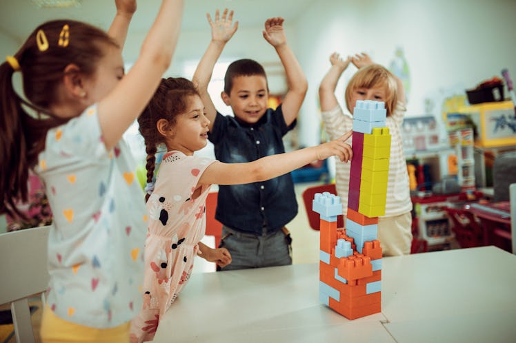 A group of kids play at a pre-school at a table