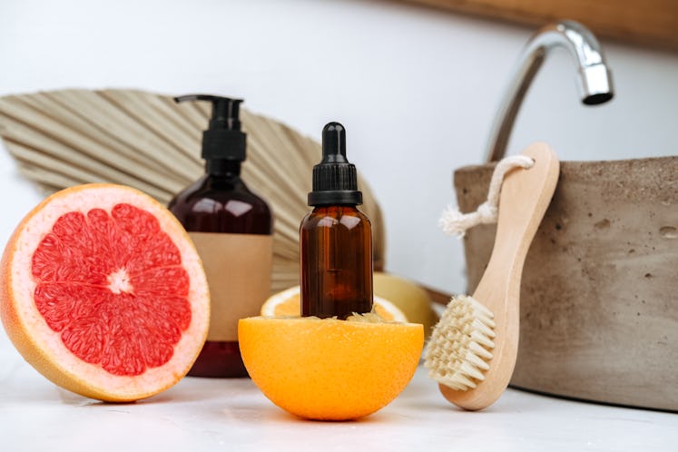 anti-aging skin care cosmetics with vitamin C serum or essential skin oil, dropper bottle and citrus...