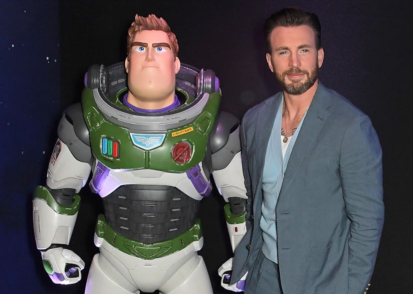 Chris Evans posing with Buzz Lightyear statue at the UK Premiere of "Lightyear" 