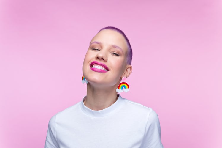 Young person with rainbow earrings. 