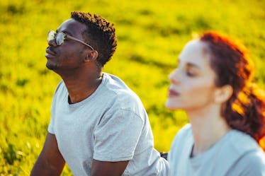 Close up of a group of male and female friends doing yoga together