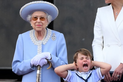 TOPSHOT - Britain's Prince Louis of Cambridge (R) holds his ears as he stands next to Britain's Quee...