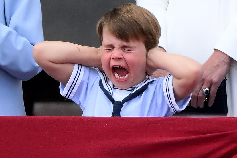 Britain's Prince Louis of Cambridge reacts as he watches a special flypast from Buckingham Palace ba...