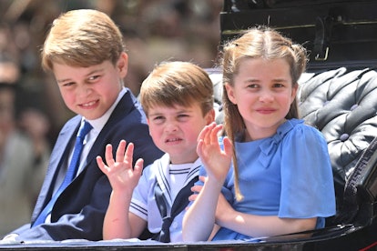 Prince George, Prince Louis, and Princess Charlotte ride in a carriage during Trooping The Colour, t...
