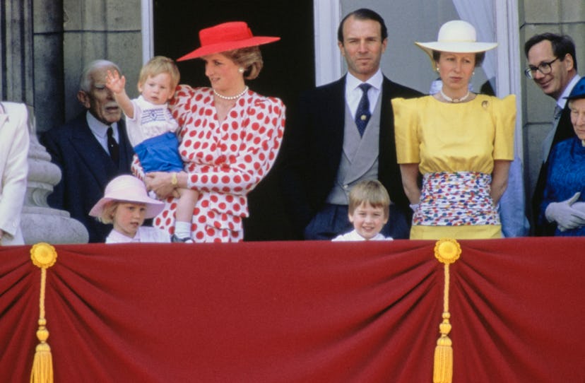 Princess Diana holding her son, Prince Harry, while watching the Trooping the Colour ceremony from t...