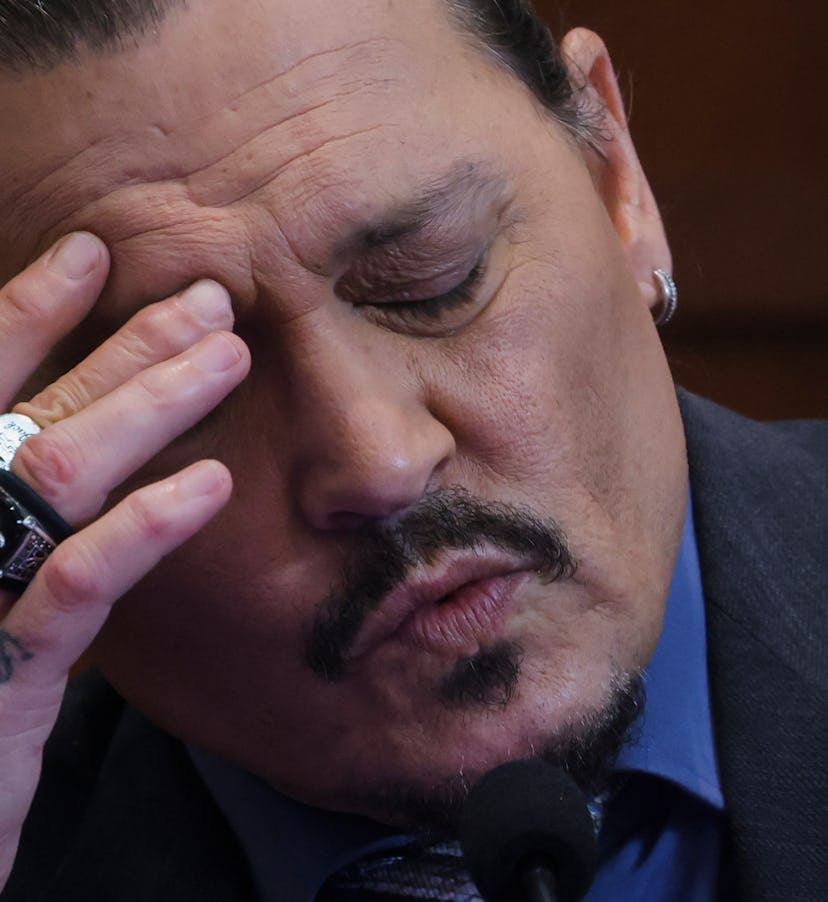 Actor Johnny Depp reacts as he testifies in the courtroom during his defamation trial against his ex...