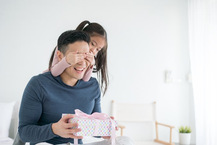 little girl giving dad a father's day card, father's day gifts for single dads