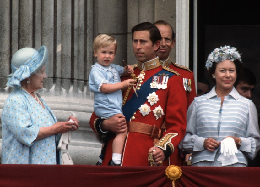 Prince Charles, Prince of Wales holds young Prince William on the balcony of Buckingham Palace.
