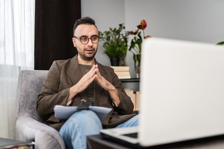 Male psychiatrist in online therapy session with his patient