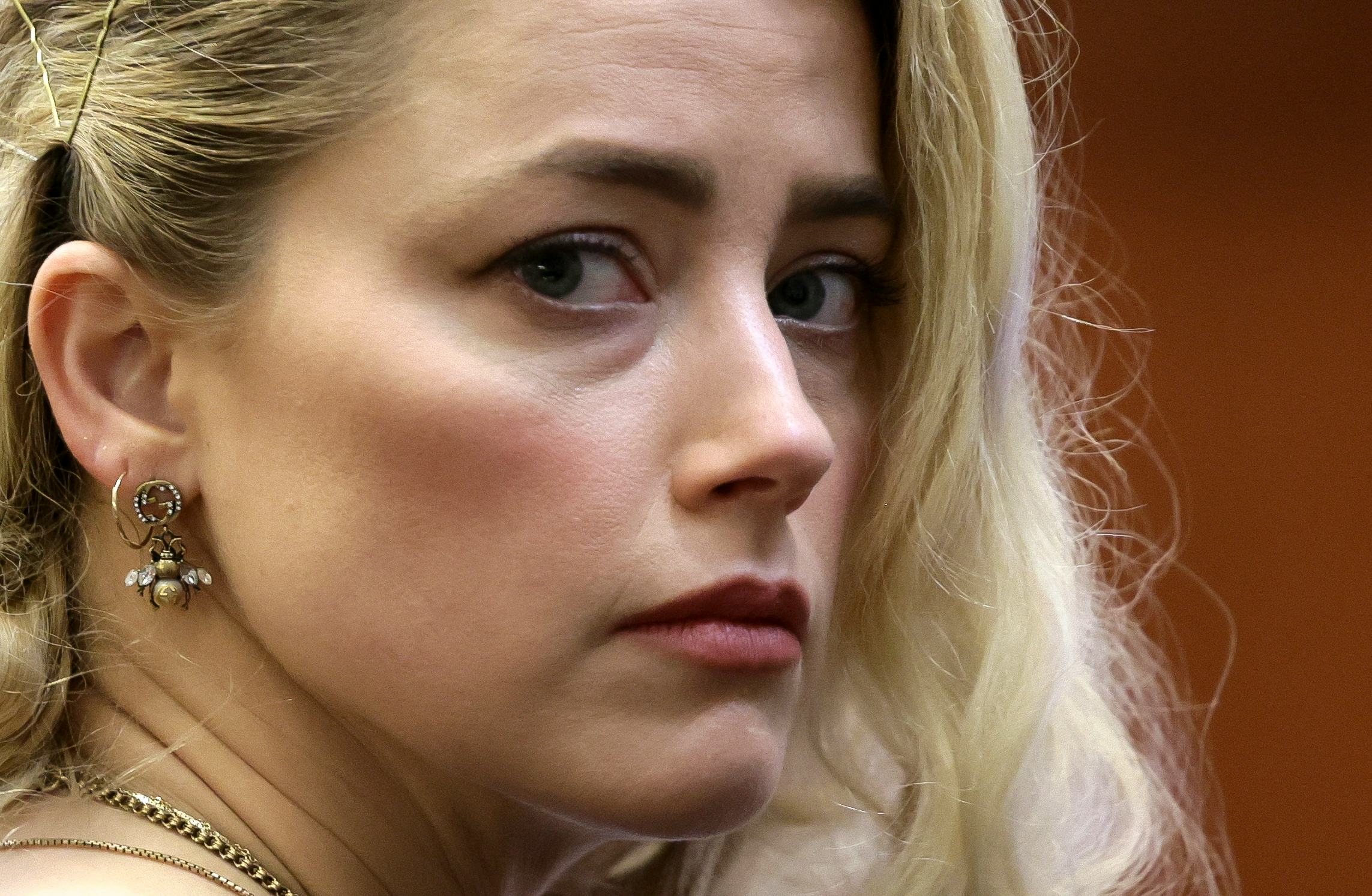 TOPSHOT - US actress Amber Heard waits before the jury announced a split verdict in favor of both Jo...