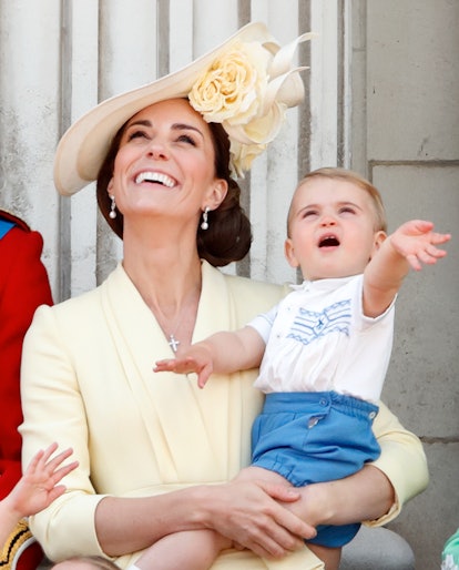 Catherine, Duchess of Cambridge and Prince Louis of Cambridge watch a flypast from the balcony of Bu...