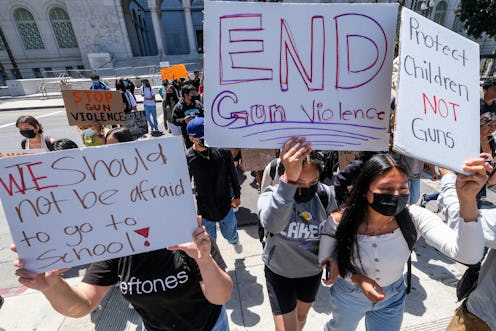 Students participate in a school walk-out and protest in front of City Hall to condemn gun violence,...