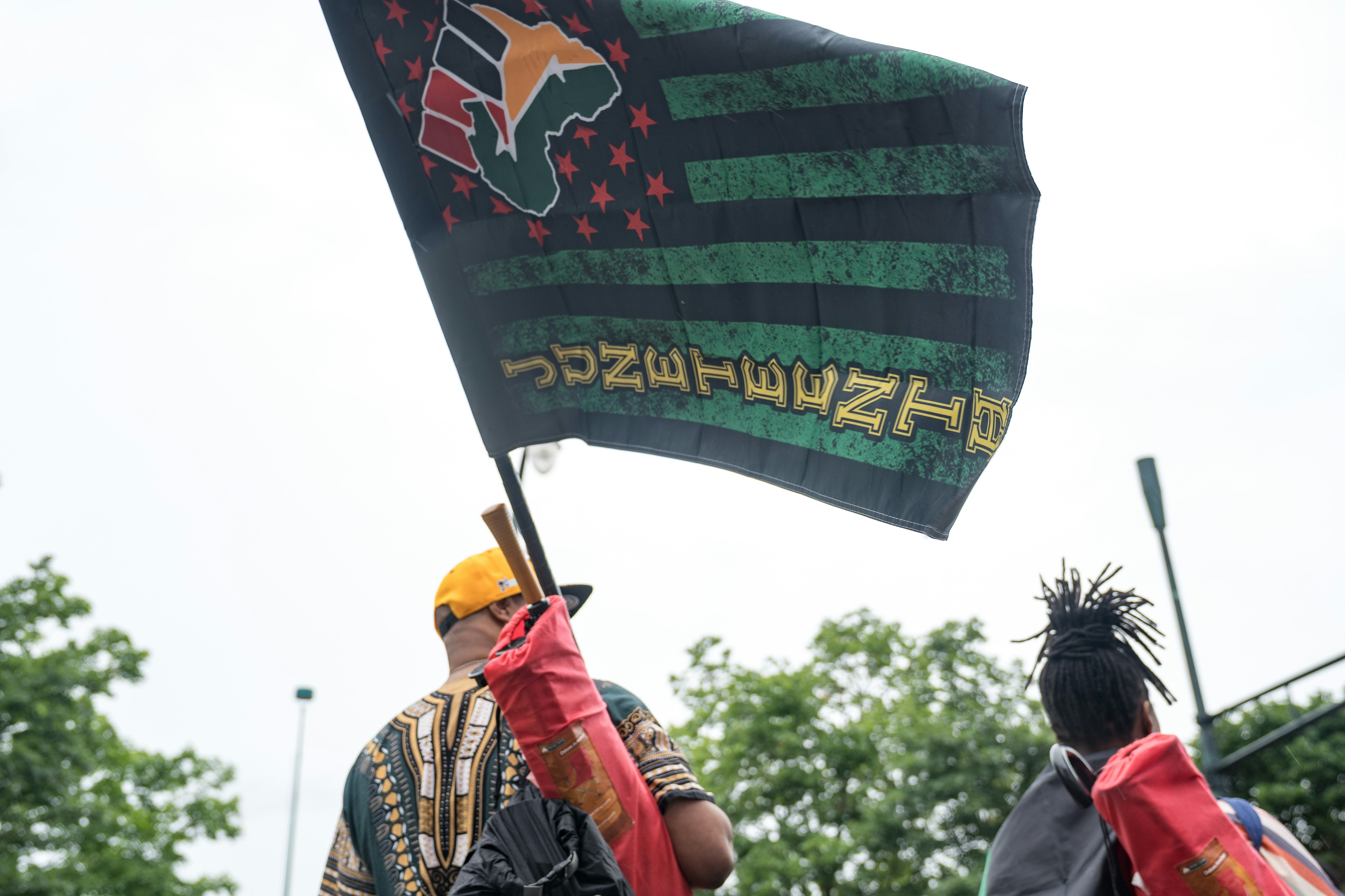 ATLANTA, GA - JUNE 19: People watch a parade taking place to celebrate Juneteenth on June 19, 2021 i...
