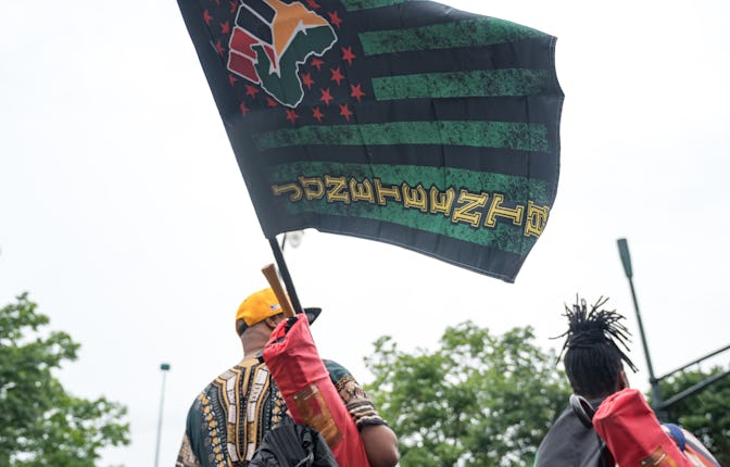 ATLANTA, GA - JUNE 19: People watch a parade taking place to celebrate Juneteenth on June 19, 2021 i...