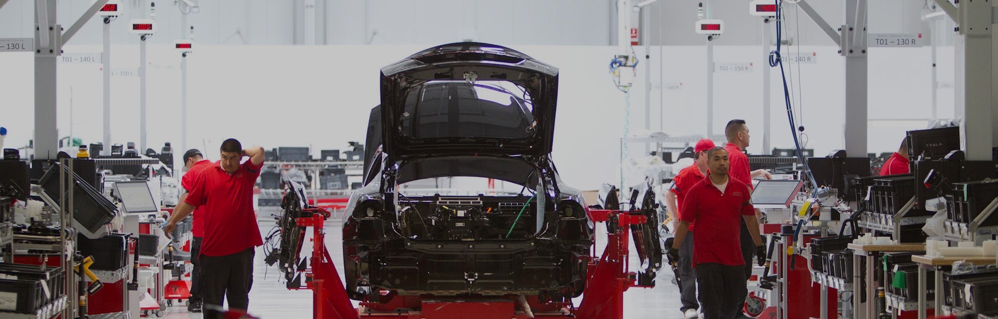 Workmen assemble a Model S sedan at the Tesla auto plant in Fremont, Calif. Tuesday, June 12, 2012. ...