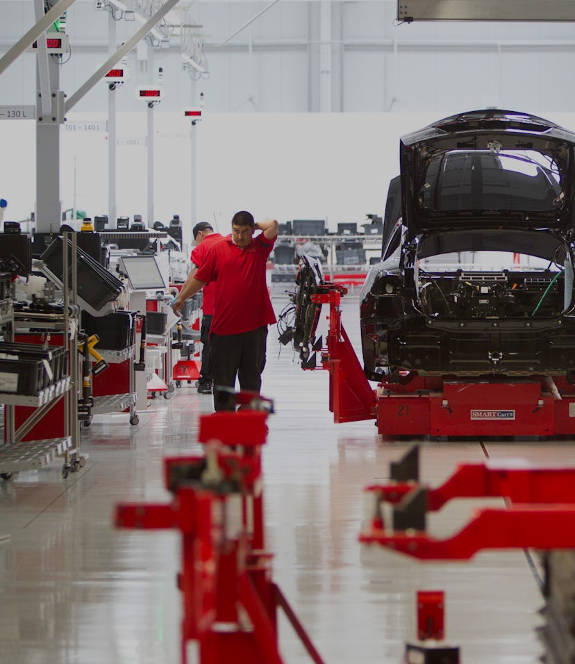 Workmen assemble a Model S sedan at the Tesla auto plant in Fremont, Calif. Tuesday, June 12, 2012. ...