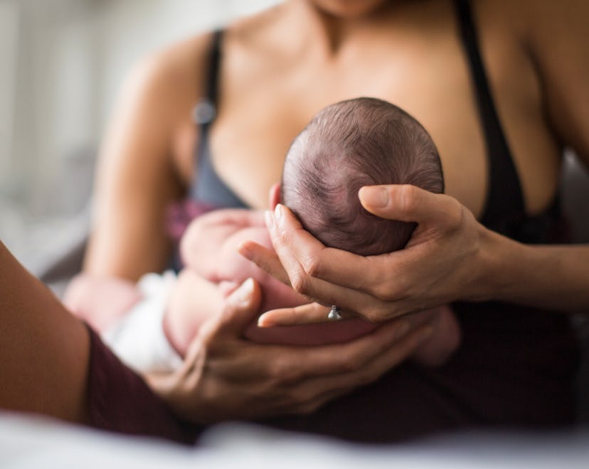 Mother breastfeeding newborn baby son, how to breastfeed baby with a cleft lip