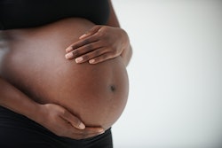 woman holding pregnant stomach, how long does it take sperm to induce labor