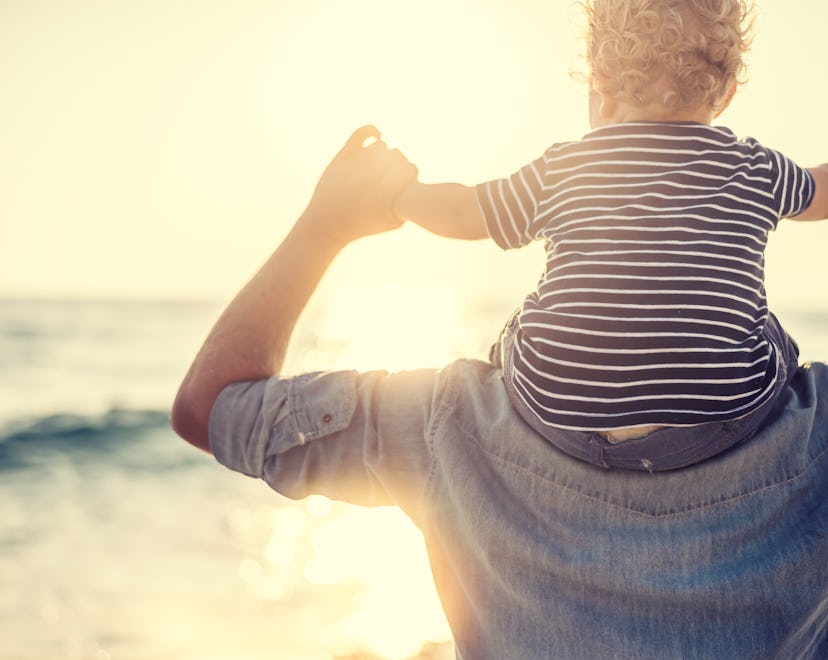 father with baby boy on shoulders at beach, summer baby boy names