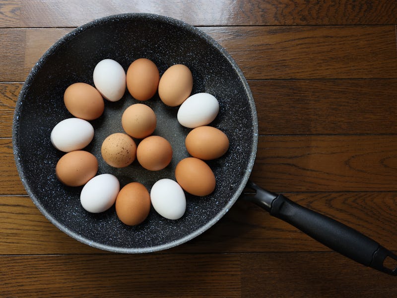 Brown and white eggs in a pan