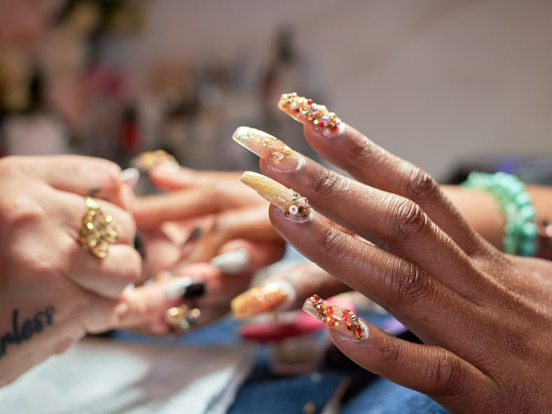 a woman's nails show 3D nail art, one of summer 2022's nail trends 
