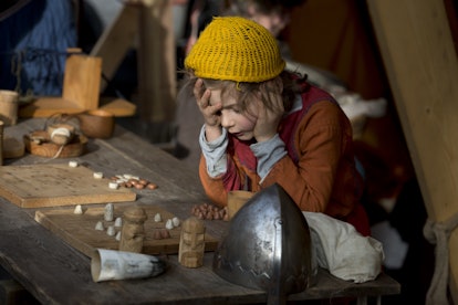 A young reenactor dressed as a Viking plays the Viking board game 'Hnefatafl' as he takes part in th...