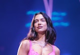 Dua Lipa performs in a pink embroidered bodysuit and matching gloves