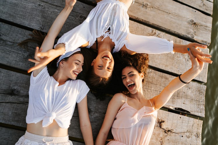 Three friends enjoying a summer at the lake as they discuss who will be the least affected by the Ju...
