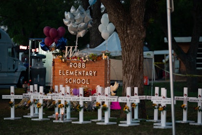 White crosses marking the deaths are pictured in front of Robb Elementary School in Uvalde, Texas ea...