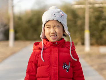 Little girl playing outdoors in winter