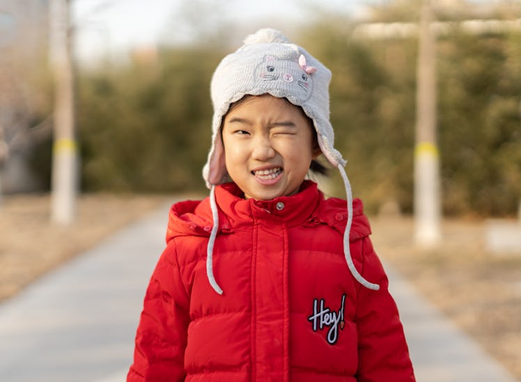 Little girl playing outdoors in winter