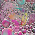 Macrophotography of oil on water, creating an abstract bubble and crater pattern