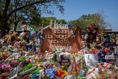 The Robb Elementary School sign is seen covered in flowers and gifts on June 17, 2022 in Uvalde, Tex...