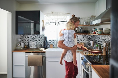 Father holding daughter and making breakfast how to ask his partner for support